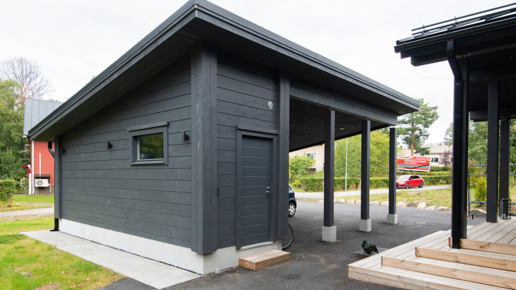 En timmerbyggd carport med pulpettak.