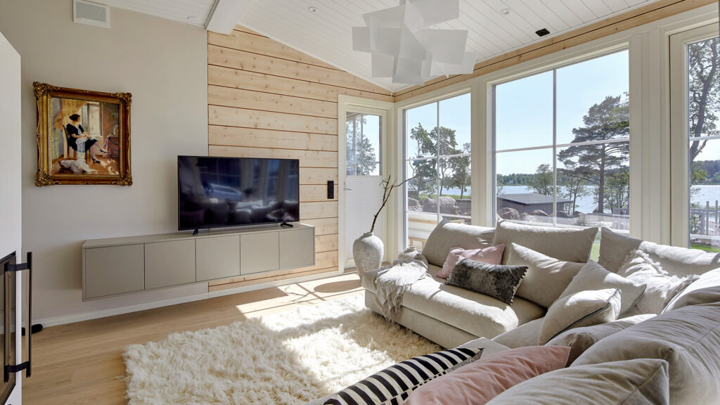 The living room has a soft, shaggy white rug. On the wall is an old painting that has been in the family for generations.