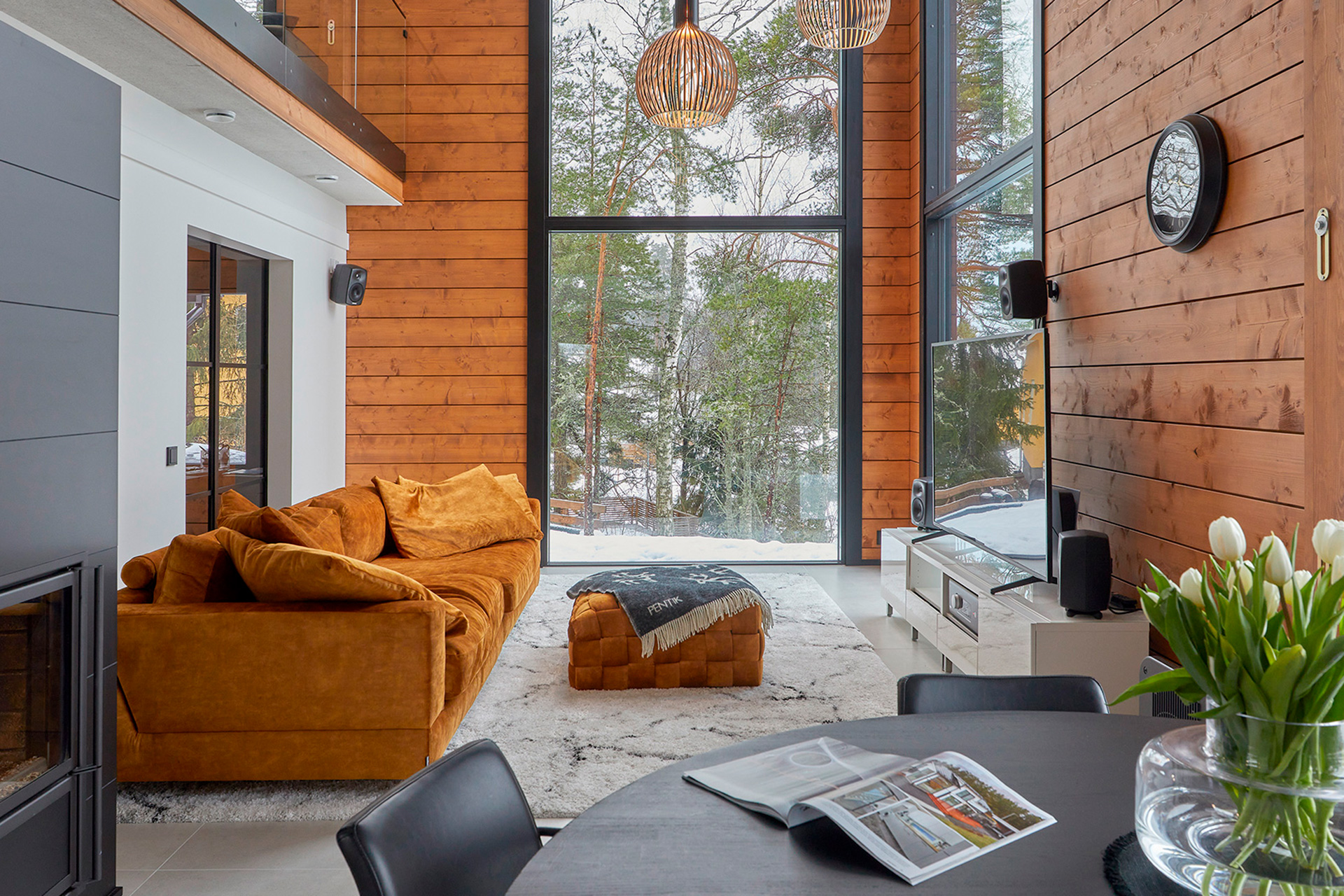 The living room features a stylish velvet sofa in orange and gold. The footstool is also in a matching shade.