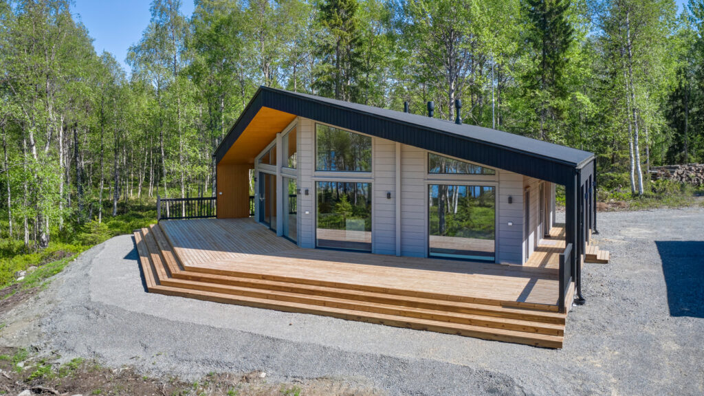 A modern log villa with plenty of terrace space at the front.
