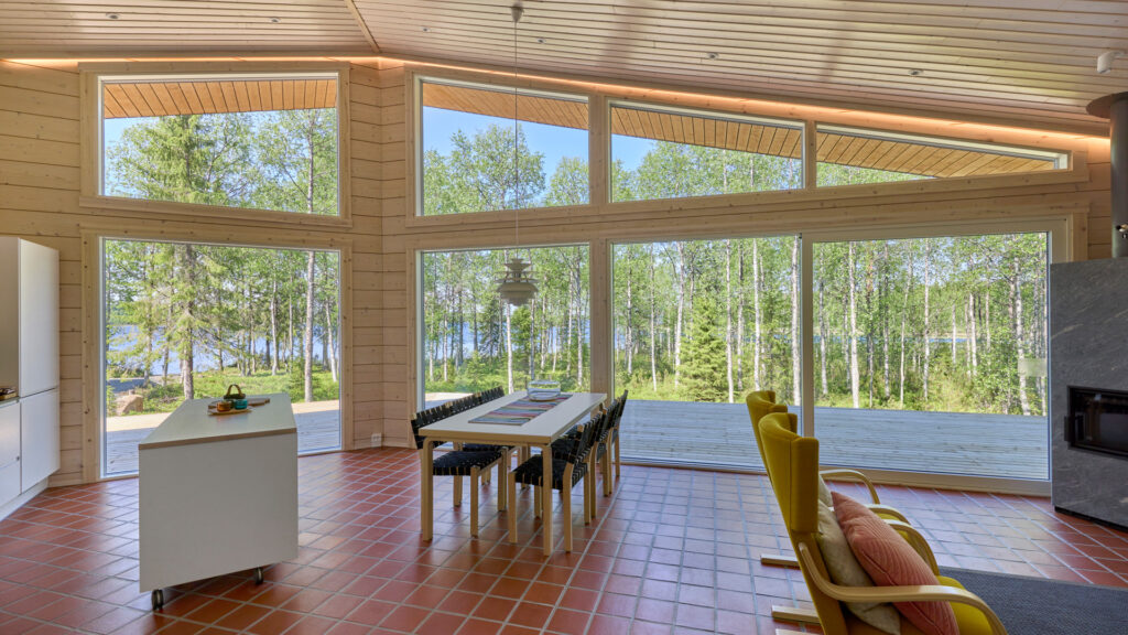 The dining area/living room of the log villa, with a tiled floor.