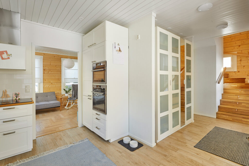The kitchen is immediately to the left of the hallway. The stairs to the upper floor are on the right.