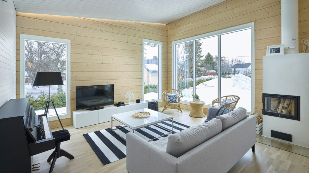 The living area offers views in two different directions. The black piano adds warmth to the space.